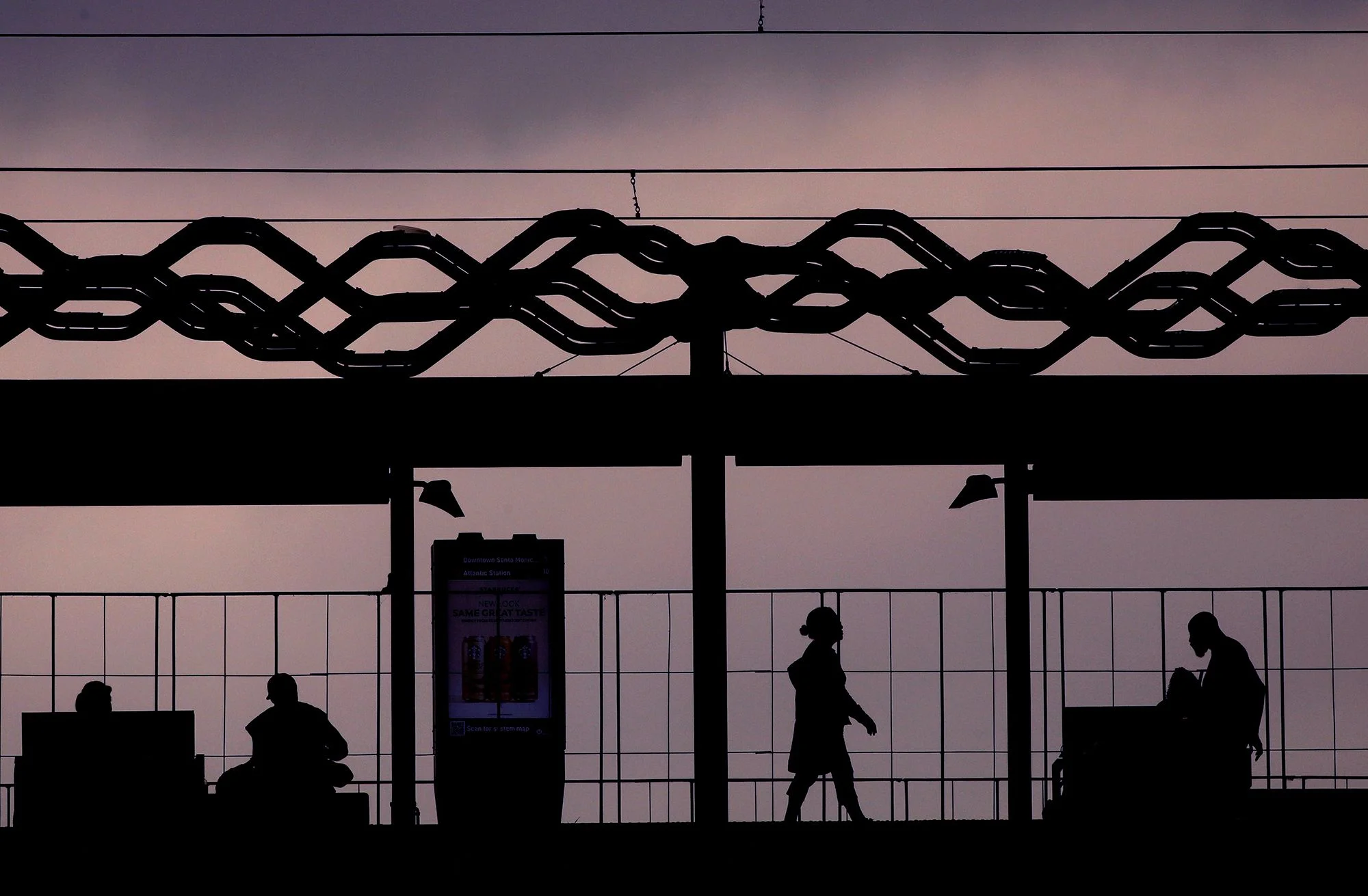 Commuters wait for a train at the MTA Expo Line Bundy Station in Culver City.