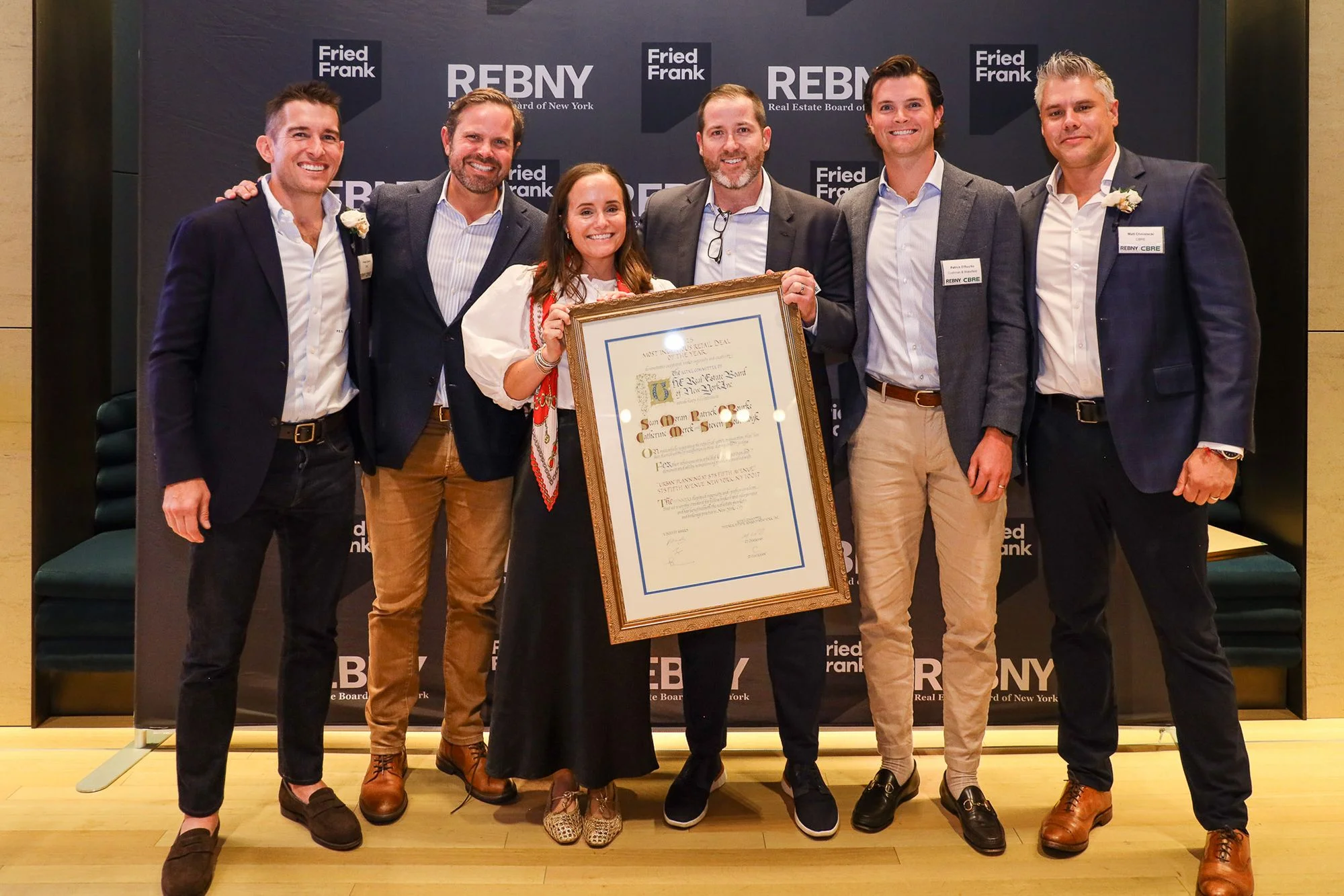 Preston Cannon (left) and Matt Chmielecki (right) of the REBNY Retail Committee present the Most Ingenious Retail Deal of the Year to the Cushman and Wakefield team who worked on the Urban Outfitters transaction at 575 Fifth Avenue.